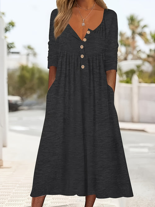 Vestido midi com botões frontais, manga comprida, bolsos e bainha com babados.