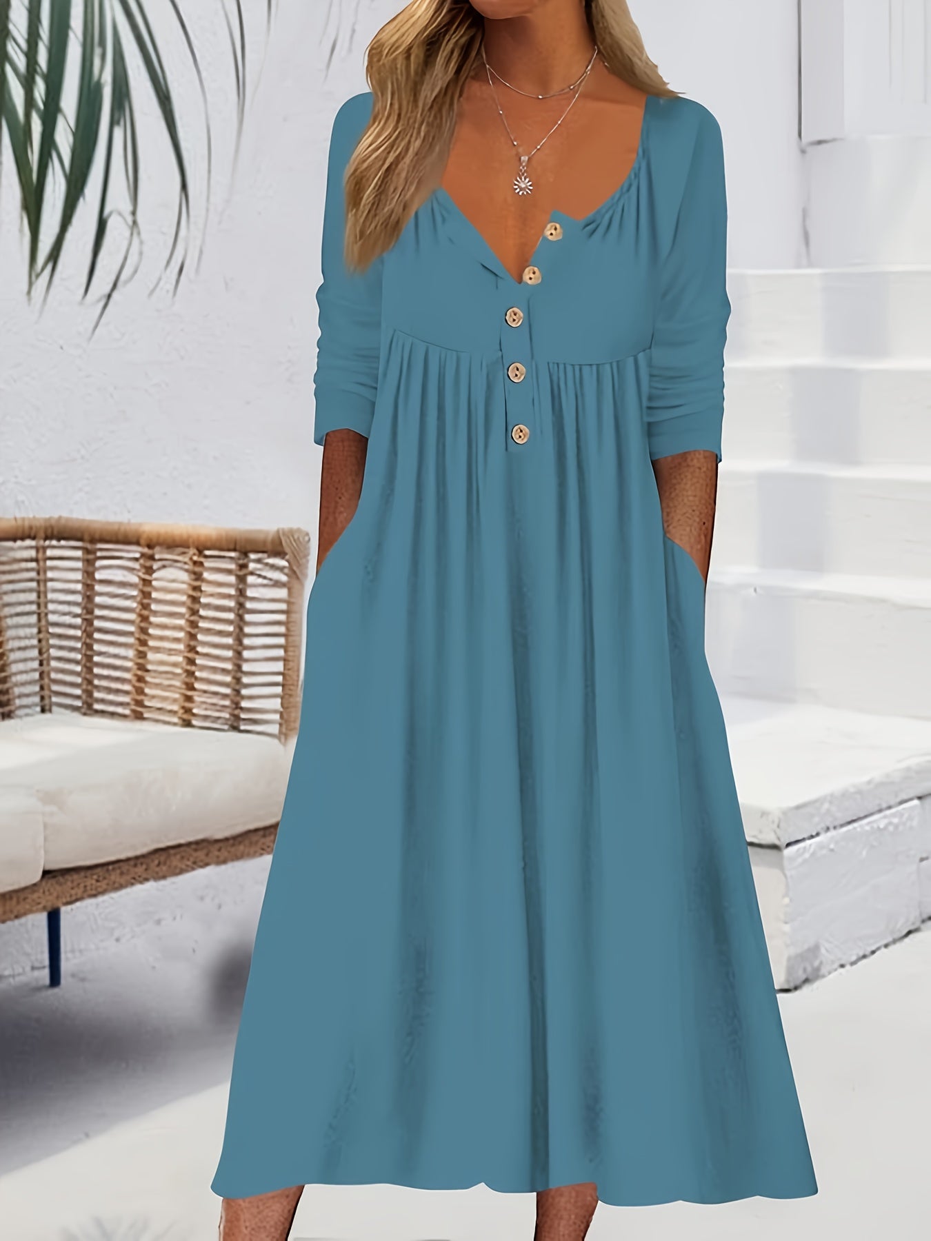 Vestido midi com botões frontais, manga comprida, bolsos e bainha com babados.